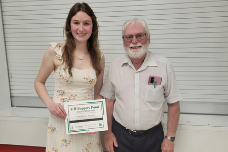 Madison Krum and Gordon Kelm stand together for the 4-H Award